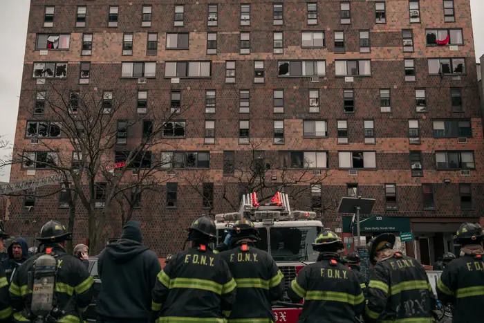 Emergency first responders remain at the scene after an intense fire at a 19-story residential building that erupted in the morning on January 9, 2022 in the Bronx. A bill inspired by the fire has been signed by Gov. Kathy Hochul.